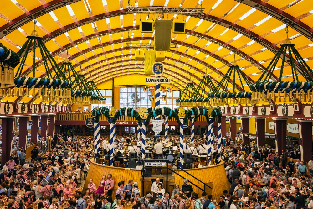 Munich,,Germany-,October,2,,2014:,People,Drinking,In,The,Lowenbrau Munich,,Germany-,October,2,,2014:,People,Drinking,In,The,Lowenbrau